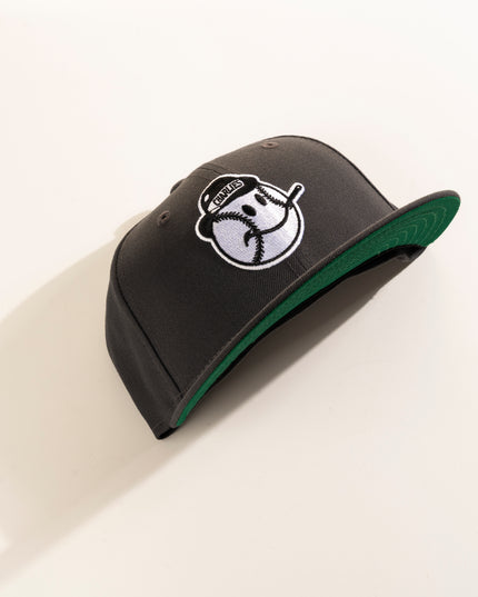 A graphite crown with green undervisor New Era Charleston Charlies 59Fifty fitted hat with a white logo on the front.