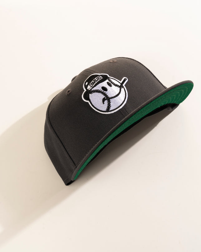 A graphite crown with green undervisor New Era Charleston Charlies 59Fifty fitted hat with a white logo on the front.