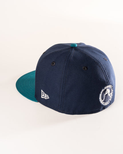 Rear profile of New Era hartford Wolf Pack 59Fifty in oceanside blue, with a shark teal visor and grey undervisor.